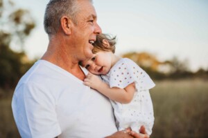 A little girl snuggling into her daddy's neck