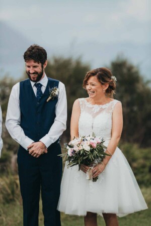 A bride & groom share a wedding day laugh