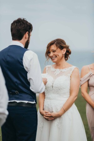 A bride listens to her partners wedding vows