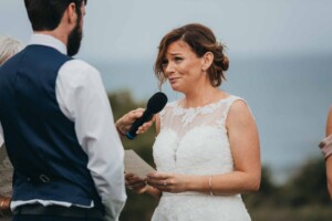 A bride reading wedding vows to her partner
