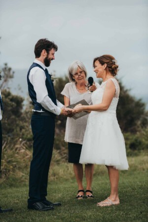 A bride & groom exchange wedding rings