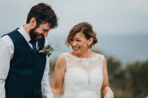 A bride & groom laughing during the wedding