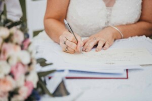 A bride signing the marriage certificate