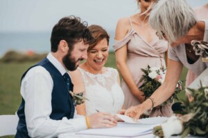 A bride & groom signing the marriage certificate