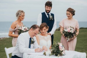 The best man signing the marriage certificate