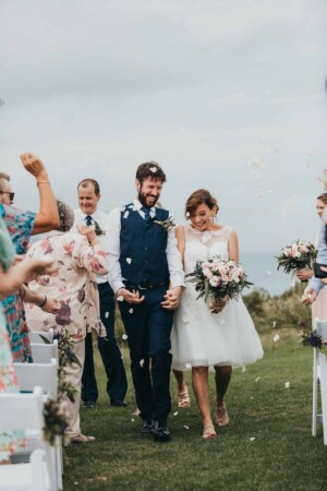 Newlyweds walk down the wedding aisle