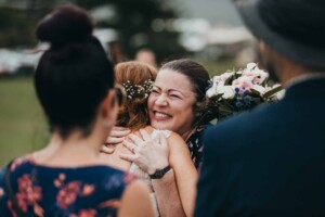 A bride hugs her wedding guests