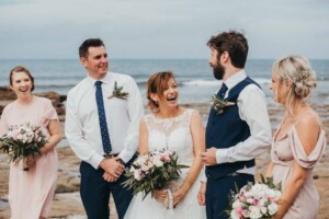 A bride and groom having fun with the bridal party