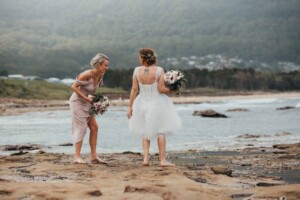 A bride her bridesmaid exploring rock pools