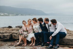 Bridal party share a giggle after the wedding