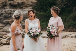 The bride and her bridesmaids share a joke