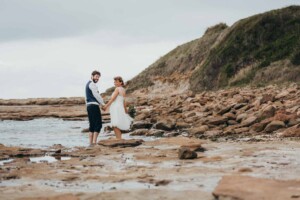 Newlyweds dip their feet in the ocean