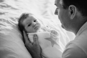 A new dad holds his newborn baby boy