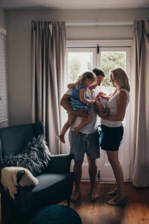 A family admiring their newborn baby boy