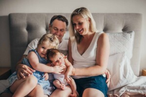 A family snuggling with their newborn baby boy