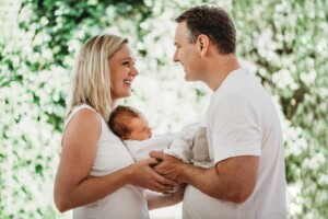 New parents holding their newborn son