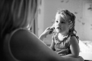 A mother strokes her baby girls hair