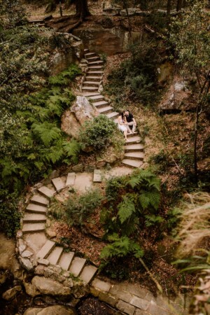 A couple embrace on the steps leading to Lennox Bridge