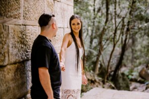 A couple holding hands and smiling at each other
