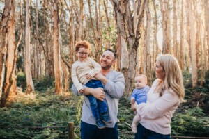 A family play games in a forest at sunset in Sydney