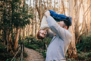 A father and son play games during the family photo shoot