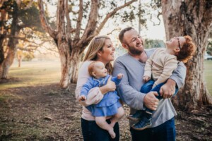 A family laugh with their kids at their family photography session