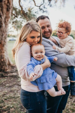 A family cuddle at sunset during their Sydney Family Photo shoot