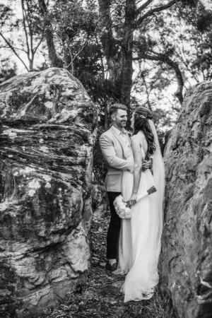 Black & white portrait of a bride and groom hugging after their wedding