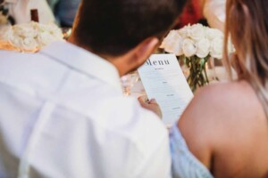 A couple read the wedding menu at Grappa in Leichhardt