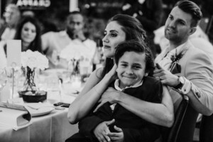 A bride hugs her nephew during the wedding reception in Leichhardt