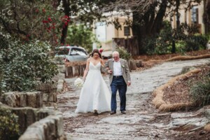 A bride & her father walk down to the wedding ceremony
