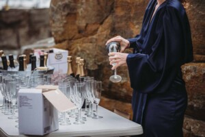 A woman pouring champagne at a wedding