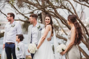 A bride smiles at her bridesmaid sister during the wedding