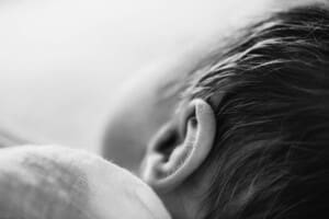 Details showing the soft lanugo hair on a newborn baby's ear