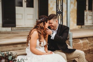 Gledswood Wedding - A groom strokes his brides face as he pulls her in for a kiss