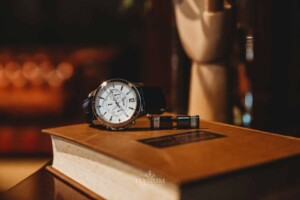 Gledswood Wedding - Detail photograph of a groom's wristwatch sitting on a book