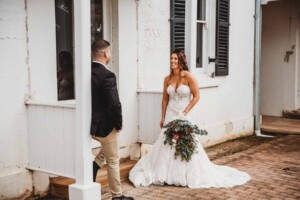 Gledswood Wedding - bride and groom stand at a rustic door of the homestead