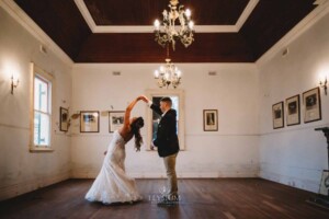 Gledswood Wedding - A groom twirls his bride as they practice their first dance in the Gledswood Homestead music room