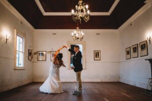 Gledswood Wedding - A groom twirls his bride as they practice their first dance in the Gledswood Homestead music room