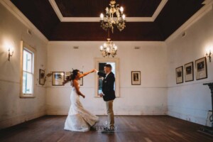 Gledswood Wedding - A groom twirls his bride as they practice their first dance in the Gledswood Homestead music room