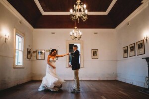 Gledswood Wedding - A groom twirls his bride as they practice their first dance in the Gledswood Homestead music room