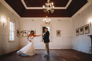 Gledswood Wedding - A groom twirls his bride as they practice their first dance in the Gledswood Homestead music room