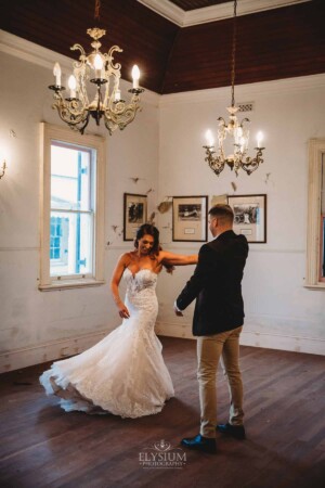 Gledswood Wedding - A groom twirls his bride as they practice their first dance in the Gledswood Homestead music room