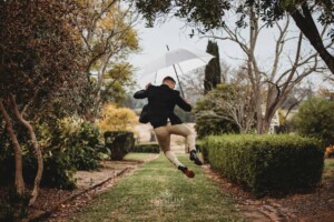 Gledswood Wedding - A groom jumps in the air kicking his heels with excitement