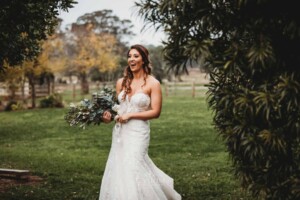 Gledswood Wedding - A bride laughs at her groom as he leaps in the air with excitement