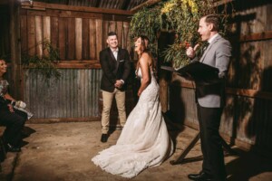 Gledswood Wedding - bride and groom laugh as their celebrant addresses the wedding guests