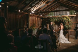 Gledswood Wedding - A bride and groom standing in front of guests at their wedding ceremony