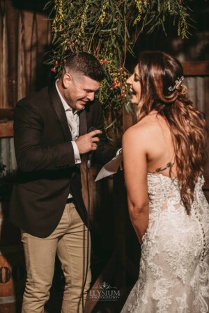Gledswood Wedding - A groom laughs as he says his wedding vows to his bride