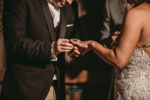 Gledswood Wedding - Detail photograph, a groom places the wedding ring on his brides finger