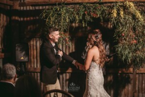 Gledswood Wedding - A bride places the wedding ring on the grooms finger